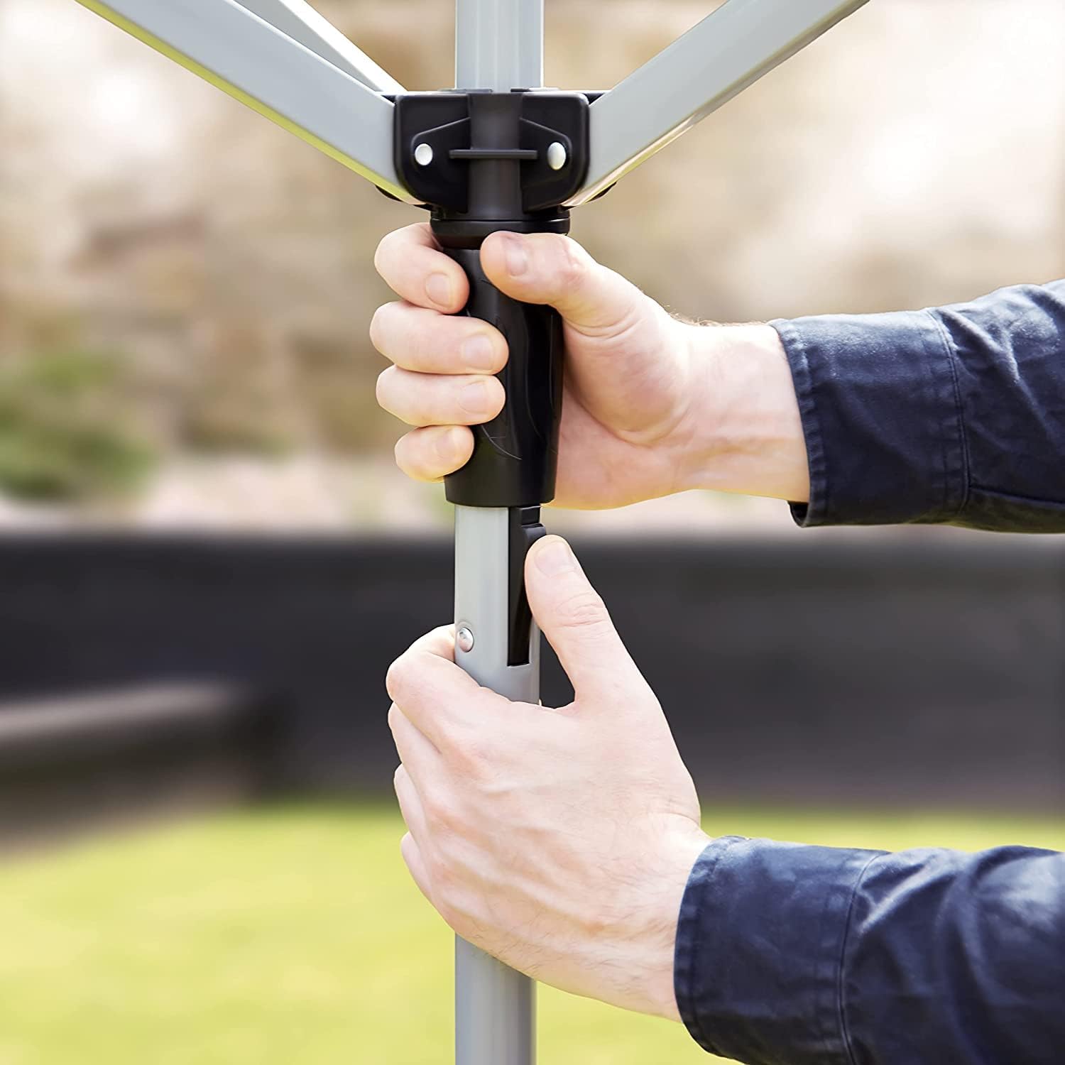 Home Treats rotary airer clothes line being set up with a hand adjusting the height for easy use