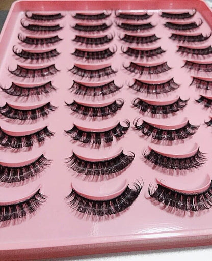 A variety of luxurious Russian strip lashes displayed on a pink tray, perfect for enhancing eye makeup