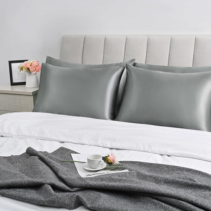 Bedcozy grey satin pillowcase for hair and skin on a neatly made bed with decorative accessories