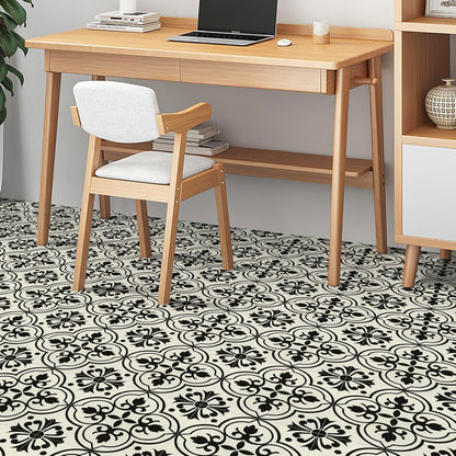 Stylish NUFLR self adhesive floor tiles 30cm x 30cm featuring a black and white floral pattern in a modern workspace