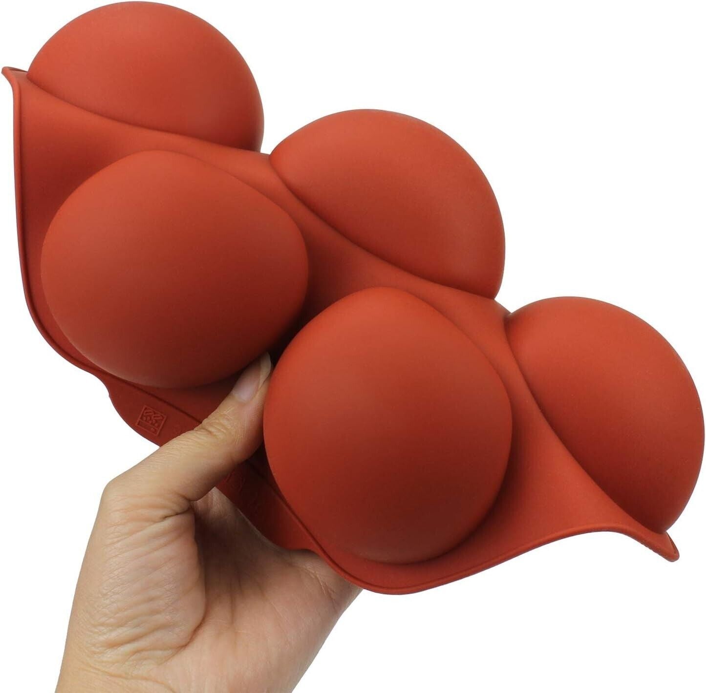 Flexible silicone chocolate mould featuring round cavities for creating shaped chocolates