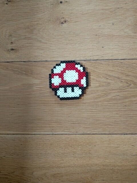 Handmade Super Mario mushroom perler bead ornament in vibrant red and white colours