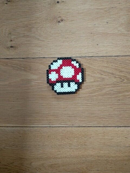Handmade Super Mario mushroom perler bead ornament in vibrant red and white colours