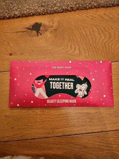 The Body Shop beauty sleeping mask packaging with a festive design and a vibrant pink background
